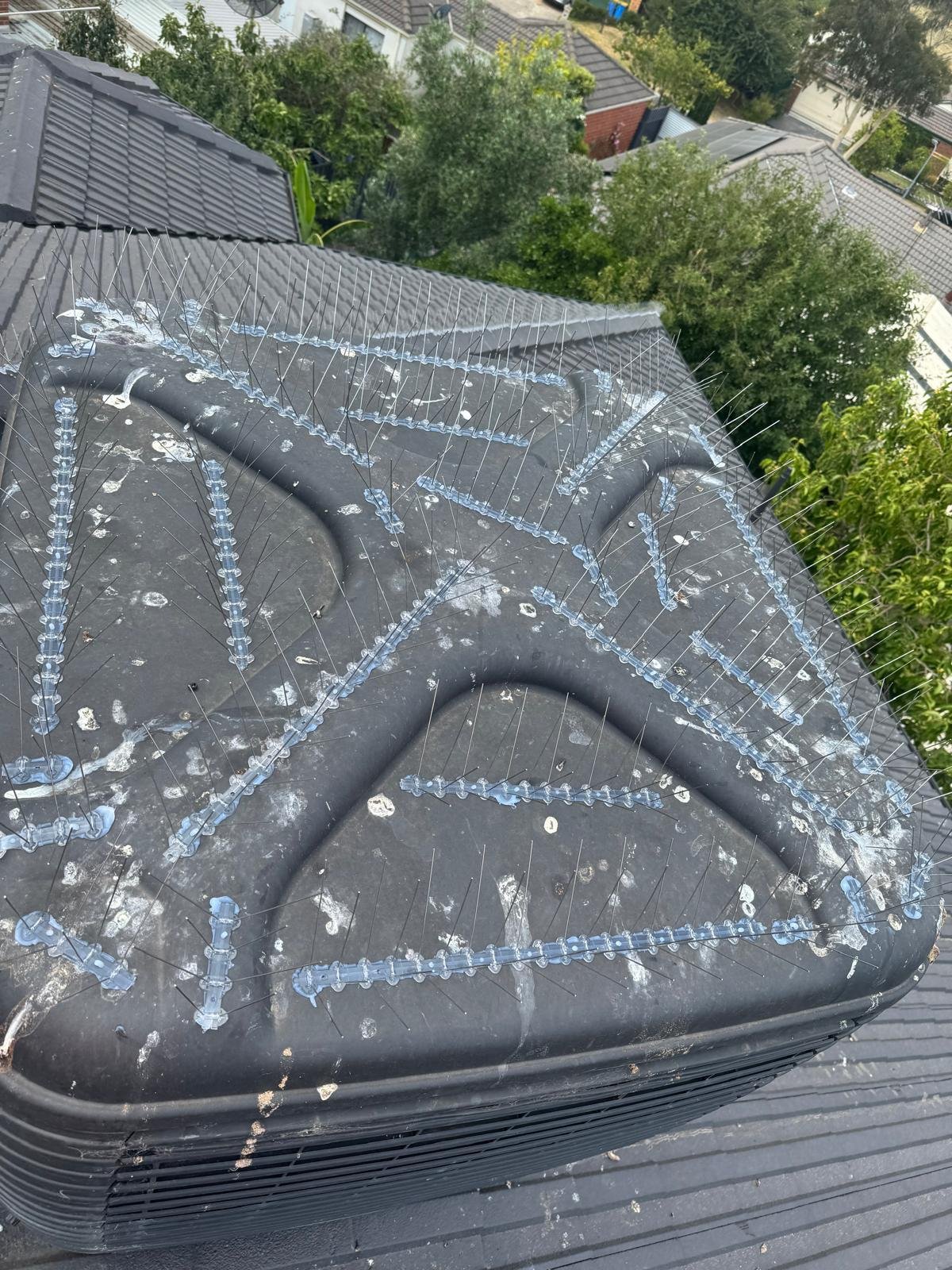 Droppings across a roof around an evaporative cooler before bird proofing
